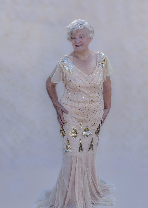 Senior woman in vintage gown standing fashion pose